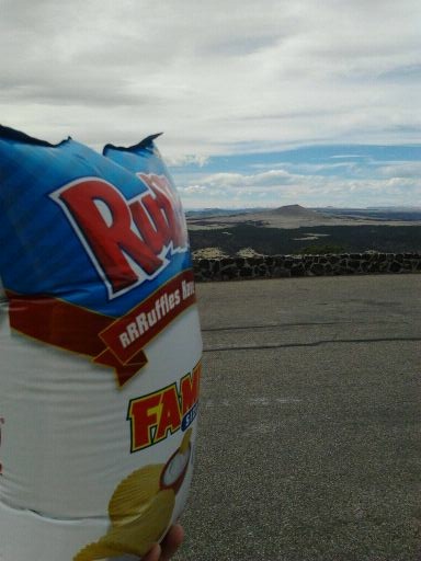 A bag of potato chips at the top of Capulin Volcano National Monument in Northeastern New Mexico. The bag has risen about 7000ft in the last two days and is fixing to explode (a bag of Sun Chips with it did.) The air pressure inside the bag is what it was when we bought it, but the outside air pressure has dropped tremendously