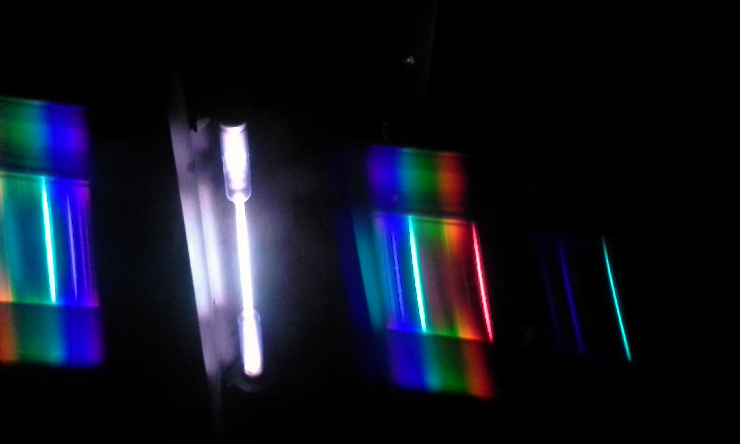 Hydrogen Gas Discharge Tube Viewed through a diffraction grating, showing hydrogen's visible electron transitions
